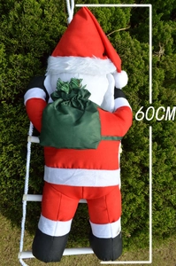 Detailed view of a 60cm climbing Santa Claus figurine with a green bag on a white rope ladder