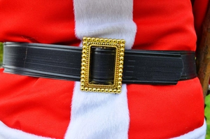 Close-up of Santa Claus black belt with a detailed gold beaded buckle on a red suit
