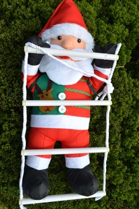 Detail of hanging Santa Claus on a climbing ladder with reindeer embroidery and white rope