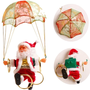 Détail du Père Noël électrique avec parachute montrant le boîtier de batterie et l'interrupteur