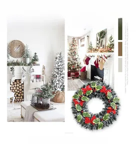 Close-up of 40cm Christmas wreath with frosted leaves, red berries and festive bows