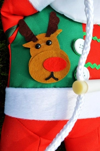 Close-up of fabric Christmas pendant with reindeer applique and decorative white buttons