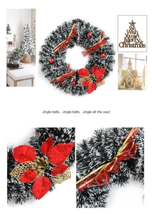 Detail of Christmas wreath with red poinsettia flowers and Merry Christmas wooden sign