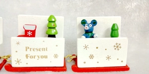 Detail of wooden Christmas train car with hand-painted tree and gold Present For You text