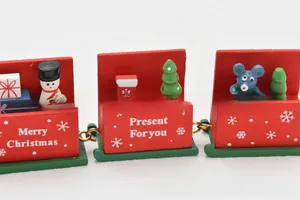 Close-up of wooden Christmas train with hand-painted snowman and festive gift details