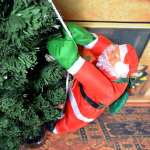 Père Noël de 50 cm grimpant sur une corde sur un sapin avec un sac de cadeaux vert