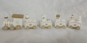 Close-up of white and gold wooden Christmas train with snowman and bear figurines