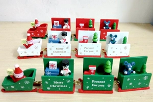 Detail of creative four-section Christmas wooden train ornament featuring snowman and Santa