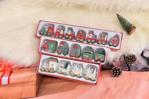 Detail of wooden Christmas train set featuring Santa, snowman and tree on faux fur background