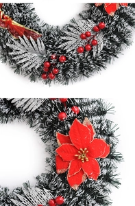 Detail of 40cm snowy pine wreath with red poinsettia, berries, and gold glitter ribbon