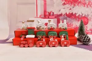 Detail of wooden Christmas train set with snowman and bear figures in holiday scene