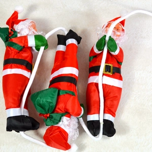 Three 25cm climbing rope Santa Claus figures on warm white plush background