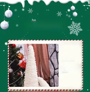 Detail of white plush cone tree topper on a Christmas tree with a festive green background