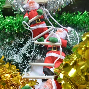 Detail of three Santa Claus figures climbing a white rope ladder for Christmas decor