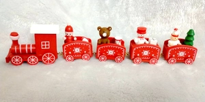 Close-up of a 5-section wooden Christmas train with festive figures on snow-like plush fabric