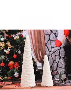 Set of two white fluffy artificial fur tabletop Christmas tree figurines in cozy home interior