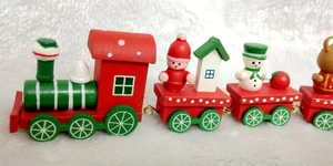 Macro shot of a four-section wooden Christmas train featuring Santa and snowman figures