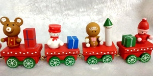 Close-up of a wooden Christmas train with miniature snowman and Santa Claus figures