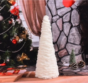 Close-up of white plush Christmas tree figurine with fluffy texture for festive home decor