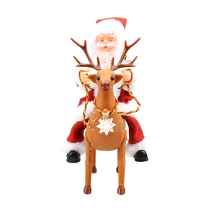 Detail of musical Santa Claus riding a reindeer with glowing star and red plush outfit