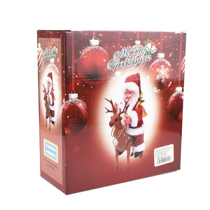 Front and side view of festive red packaging for a musical Santa riding a reindeer toy