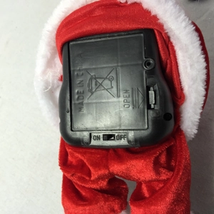Detail of Santa music box battery compartment with ON/OFF switch and red velvet fabric