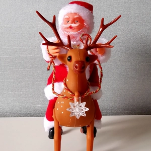 Electric Santa Claus riding a reindeer toy with music for Christmas holiday decorations