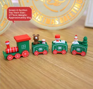 Macro detail of a 4-section green wooden Christmas train with miniature holiday figures