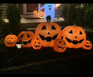 Outdoor Halloween inflatable decor set featuring 7 glowing pumpkins and a white Boo ghost