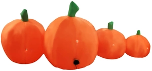 Detail of four inflatable Halloween pumpkins in a row with green stems and light connectors