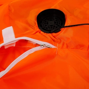 Detail of the white zipper and integrated black cooling fan on an orange inflatable pumpkin