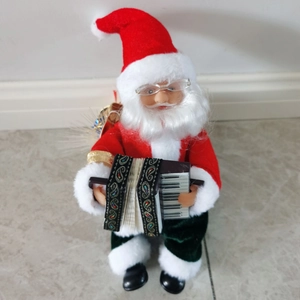 Close-up of animated Santa Claus figure in red suit playing a vintage accordion