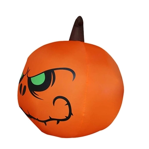 Close-up of inflatable Halloween pumpkin with glowing green eyes and evil stitched smile