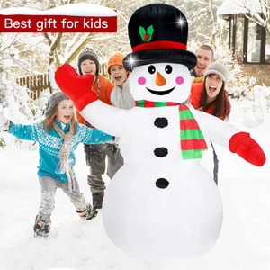 Giant inflatable snowman in snow-covered yard with a happy family for Christmas decor