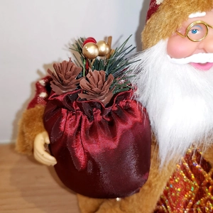 Classic sitting Santa Claus doll with red satin gift bag and pine cone decorations