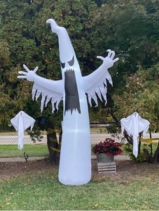 Detail of inflatable Halloween ghosts set with pumpkin and serrated fringe for outdoor decor