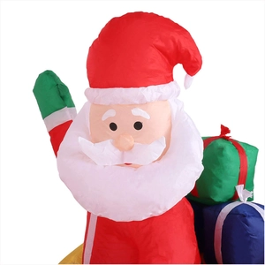 Close-up of inflatable Santa Claus with colorful gift boxes for festive yard decoration