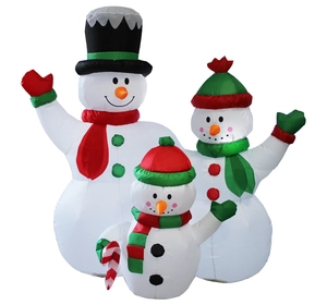 Detailed view of three inflatable Christmas snowmen with scarves and hats for garden decor