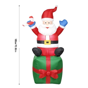 1.8m inflatable Santa Claus sitting on a giant green gift box with a red bow for outdoor decor