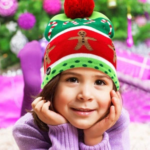 Detail view of the ON/OFF switch on the colorful knitted LED Christmas hat for kids