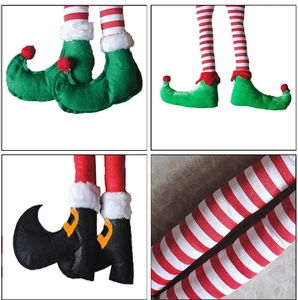 Macro detail of Christmas elf leg decorations featuring red white stripes and festive shoes