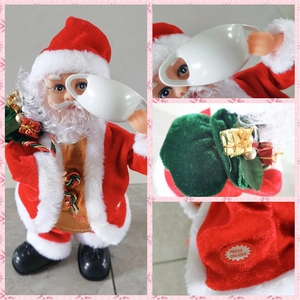 Detail view of electric dancing Santa Claus figure with gift bag and On-Off button