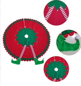 Detail view of red Christmas tree skirt with elf legs and green star pattern design