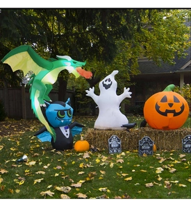 Detailed outdoor Halloween scene with inflatable green dragon, ghost, and glowing pumpkin