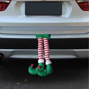 Detail of striped Christmas elf legs hanging from a white SUV trunk for car holiday decor