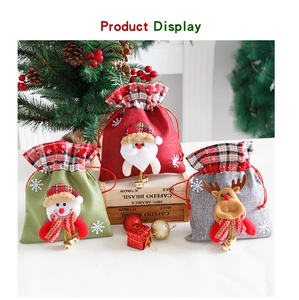 Detail of Christmas drawstring linen gift bags with cartoon 3D dolls and gold bells