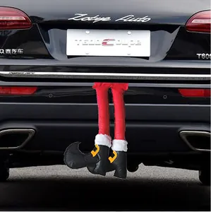 Festive red and white plush elf legs decoration attached to a car trunk for Christmas