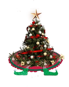 Detail of red and green Christmas tree skirt with festive stuffed elf legs decoration