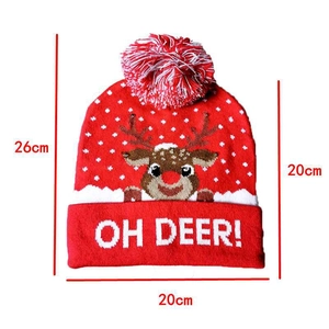 Detailed dimension drawing of red knitted Christmas hat with reindeer pattern and pompom