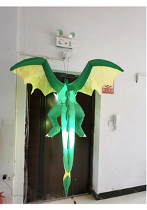 Macro detail of inflatable green dragon with internal LED lights and power cord for outdoor use